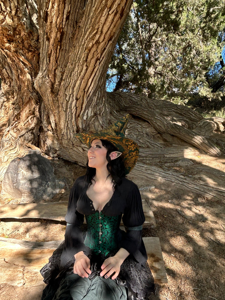 Person lying on a large tree trunk with a scenic background
